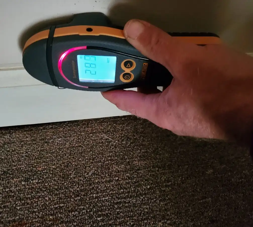 Moisture detection at baseboard during Storm Damage Restoration in Riverhead